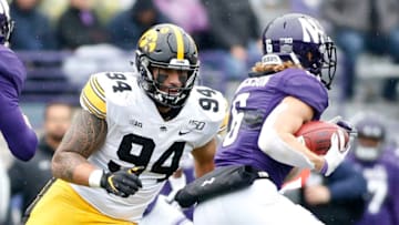 EVANSTON, ILLINOIS - OCTOBER 26: A.J. Epenesa #94 of the Iowa Hawkeyes tackles Drake Anderson #6 of the Northwestern Wildcats at Ryan Field on October 26, 2019 in Evanston, Illinois. (Photo by Justin Casterline/Getty Images)