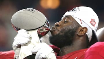 ARLINGTON, TX - DECEMBER 07: Neville Gallimore #90 of the Oklahoma Sooners kisses the trophy after Oklahoma defeated the Baylor Bears 30-23 in the Big 12 Football Championship at AT&T Stadium on December 7, 2019 in Arlington, Texas. (Photo by Ron Jenkins/Getty Images)