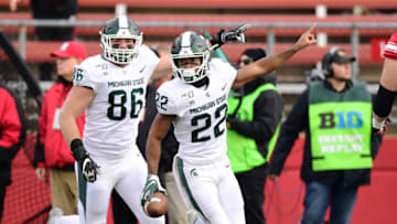 PISCATAWAY, NEW JERSEY - NOVEMBER 23: Drew Beesley #86 and Josiah Scott #22 of the Michigan State Spartans react during the second half of their game against the Rutgers Scarlet Knights at SHI Stadium on November 23, 2019 in Piscataway, New Jersey. (Photo by Emilee Chinn/Getty Images)