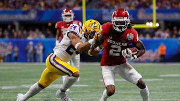 ATLANTA, GEORGIA - DECEMBER 28: Wide receiver CeeDee Lamb #2 of the Oklahoma Sooners carries the ball against Derek Stingley Jr. #24 of the LSU Tigers during the Chick-fil-A Peach Bowl at Mercedes-Benz Stadium on December 28, 2019 in Atlanta, Georgia. (Photo by Kevin C. Cox/Getty Images)