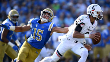PASADENA, CA - SEPTEMBER 01: Desmond Ridder #9 of the Cincinnati Bearcats runs from Jaelan Phillips #15 of the UCLA Bruins at Rose Bowl on September 1, 2018 in Pasadena, California. (Photo by Harry How/Getty Images)