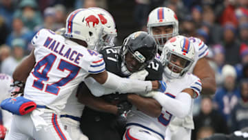 BUFFALO, NY - NOVEMBER 25: Leonard Fournette #27 of the Jacksonville Jaguars is tackled by Micah Hyde #23 of the Buffalo Bills and Levi Wallace #47 as he runs with the ball in the third quarter during NFL game action at New Era Field on November 25, 2018 in Buffalo, New York. (Photo by Tom Szczerbowski/Getty Images)