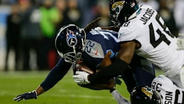 NASHVILLE, TN - DECEMBER 6: Derrick Henry #22 of the Tennessee Titans is tackled by Leon Jacobs #48 of the Jacksonville Jaguars and Ronnie Harrison #36 during the first quarter at Nissan Stadium on December 6, 2018 in Nashville, Tennessee. (Photo by Silas Walker/Getty Images)