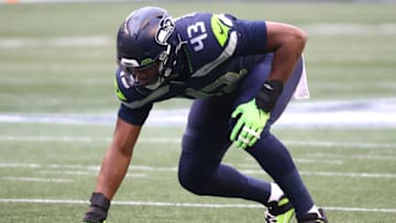 SEATTLE, WASHINGTON - JANUARY 09: Carlos Dunlap #43 of the Seattle Seahawks lines up for play in the second quarter against the Los Angeles Rams during the NFC Wild Card Playoff game at Lumen Field on January 09, 2021 in Seattle, Washington. (Photo by Abbie Parr/Getty Images)