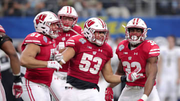 ARLINGTON, TX - JANUARY 02: T.J. Edwards #53, Alec James #57, and Leon Jacobs #32 of the Wisconsin Badgers celebrate in the fourth quarter during the 81st Goodyear Cotton Bowl Classic between Western Michigan and Wisconsin at AT&T Stadium on January 2, 2017 in Arlington, Texas. (Photo by Tom Pennington/Getty Images)