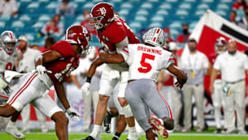 Jan 11, 2021; Miami Gardens, Florida, USA; Ohio State Buckeyes linebacker Baron Browning (5) forces Alabama Crimson Tide quarterback Mac Jones (10) to fumble during the second quarter in the 2021 College Football Playoff National Championship Game. Mandatory Credit: Kim Klement-USA TODAY Sports