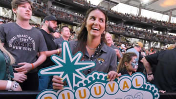 Kari Troia, an event coordinator for the Jacksonville Jaguars with her Draft 2022 sign at Thursday evening's draft party. [Bob Self/Florida Times-Union]