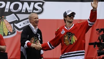 Jun 18, 2015; Chicago, IL, USA; Chicago Blackhawks defenseman Niklas Hjalmarsson (4) greets fans as she shakes hands with Illinois Governor Bruce Rauner during the 2015 Stanley Cup championship rally at Soldier Field. Mandatory Credit: Matt Marton-USA TODAY Sports