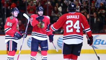 Jan 3, 2016; Chicago, IL, USA; Chicago Blackhawks center Andrew Desjardins (11) celebrates with left wing Teuvo Teravainen (86) and left wing Phillip Danault (24) after scoring an empty net goal against the Ottawa Senators during the third period at United Center. Mandatory Credit: Jerry Lai-USA TODAY Sports