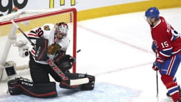Jan 14, 2016; Montreal, Quebec, CAN; Chicago Blackhawks goalie Corey Crawford (50) makes a save against Montreal Canadiens left wing Tomas Fleischmann (15) during the third period at Bell Centre. Mandatory Credit: Jean-Yves Ahern-USA TODAY Sports