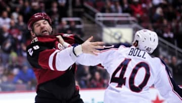 Dec 17, 2015; Glendale, AZ, USA; Arizona Coyotes left wing John Scott (28) and Columbus Blue Jackets right wing Jared Boll (40) fight during the second period at Gila River Arena. Mandatory Credit: Matt Kartozian-USA TODAY Sports