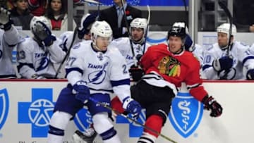 Nov 11, 2014; Chicago, IL, USA; Tampa Bay Lightning left wing Jonathan Drouin (27) checks Chicago Blackhawks center Brad Richards (91) during the first period at the United Center. Mandatory Credit: David Banks-USA TODAY Sports