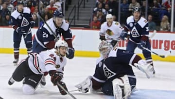 Dec 31, 2015; Denver, CO, USA; Chicago Blackhawks left wing Phillip Danault (24) dives to shoot the puck against Colorado Avalanche goalie Semyon Varlamov (1) during the third period at Pepsi Center. The Blackhawks won 4-3 in overtime. Mandatory Credit: Chris Humphreys-USA TODAY Sports
