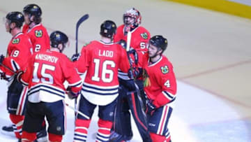 Feb 28, 2016; Chicago, IL, USA; Chicago Blackhawks goalie Corey Crawford (50) is congratulated for earning the win by left wing Andrew Ladd (16) against the Washington Capitals at the United Center. Chicago won 3-2. Mandatory Credit: Dennis Wierzbicki-USA TODAY Sports