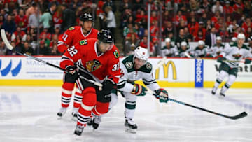 Mar 20, 2016; Chicago, IL, USA; Chicago Blackhawks defenseman Michal Rozsival (32) and Minnesota Wild left wing Jason Zucker (16) chase the puck during the second period at the United Center. Mandatory Credit: Dennis Wierzbicki-USA TODAY Sports
