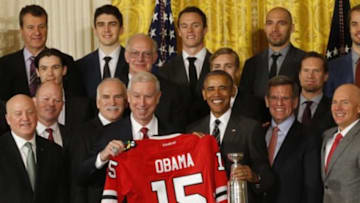 Feb 18, 2016; Washington, DC, USA; President Barack Obama (M) is presented with a replica Stanley Cup and honorary jersey by (L-R) NHL deputy commissioner Bill Daly, Chicago Blackhawks president and chief executive officer John McDonough, and owner Rocky Wertz at a ceremony honoring the 2015 Stanley Cup champion Blackhawks in the East Room at the White House. Mandatory Credit: Geoff Burke-USA TODAY Sports