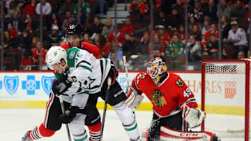 Mar 22, 2016; Chicago, IL, USA; Dallas Stars right wing Brett Ritchie (25) and Chicago Blackhawks defenseman Trevor van Riemsdyk (57) fight for the puck in front of goalie Michael Leighton (49) during the third period at the United Center. Dallas won 6-2. Mandatory Credit: Dennis Wierzbicki-USA TODAY Sports