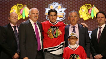 Jun 27, 2014; Philadelphia, PA, USA; Nick Schmaltz poses for a photo with team officials after being selected as the number twenty overall pick to the Chicago Blackhawks in the first round of the 2014 NHL Draft at Wells Fargo Center. Mandatory Credit: Bill Streicher-USA TODAY Sports