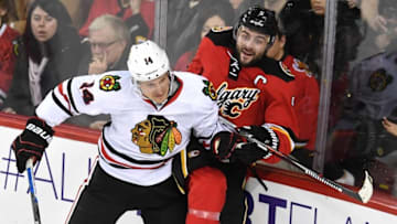Mar 26, 2016; Calgary, Alberta, CAN; Chicago Blackhawks left wing Richard Panik (14) collides with Calgary Flames defenseman Mark Giordano (5) at Scotiabank Saddledome. Blackhawks won 4-1. Mandatory Credit: Candice Ward-USA TODAY Sports
