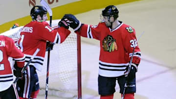 Apr 5, 2016; Chicago, IL, USA; Chicago Blackhawks center Andrew Desjardins (11) celebrates with Chicago Blackhawks defenseman Michal Rozsival (32) after scoring a goal in the third period against the Arizona Coyotes at the United Center. Mandatory Credit: Matt Marton-USA TODAY Sports