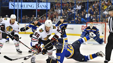 Apr 25, 2016; St. Louis, MO, USA; Chicago Blackhawks center Andrew Shaw (65) and St. Louis Blues center Jori Lehtera (12) face off during the first period in game seven of the first round of the 2016 Stanley Cup Playoffs at Scottrade Center. Mandatory Credit: Jasen Vinlove-USA TODAY Sports