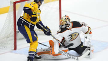Nov 17, 2015; Nashville, TN, USA; Anaheim Ducks goalie Anton Khudobin (30) makes a save with pressure from Nashville Predators center Colin Wilson (33) during the second period at Bridgestone Arena. Mandatory Credit: Christopher Hanewinckel-USA TODAY Sports