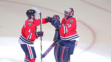 Apr 23, 2016; Chicago, IL, USA; Chicago Blackhawks goalie Corey Crawford (right) is congratulated by defenseman Niklas Hjalmarsson (left) following the conclusion of the third period in game six of the first round of the 2016 Stanley Cup Playoffs against the St. Louis Blues at the United Center. Chicago won 6-3. Mandatory Credit: Dennis Wierzbicki-USA TODAY Sports