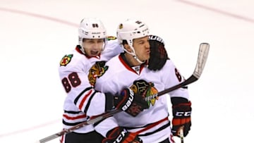 Apr 15, 2016; St. Louis, MO, USA; Chicago Blackhawks center Andrew Shaw (65) celebrates with Patrick Kane (88) after scoring a goal against St. Louis Blues goalie Brian Elliott (not pictured) during the third period in game two of the first round of the 2016 Stanley Cup Playoffs at Scottrade Center. The Blackhawks won the game 3-2. Mandatory Credit: Billy Hurst-USA TODAY Sports