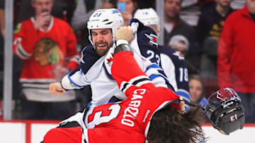 Dec 23, 2014; Chicago, IL, USA; Chicago Blackhawks left wing Daniel Carcillo (13) and Winnipeg Jets defenseman Jay Harrison (23) fight during the first period at the United Center. Mandatory Credit: Dennis Wierzbicki-USA TODAY Sports
