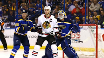 Apr 21, 2016; St. Louis, MO, USA; St. Louis Blues goalie Brian Elliott (1) looks through the screen of Chicago Blackhawks center Jonathan Toews (19) as he is marked by center Paul Stastny (26) during game five of the first round of the 2016 Stanley Cup Playoffs at Scottrade Center. The Blackhawks won the game 4-3 in double overtime. Mandatory Credit: Billy Hurst-USA TODAY Sports