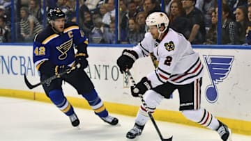 Oct 25, 2014; St. Louis, MO, USA; Chicago Blackhawks defenseman Duncan Keith (2) passes the puck under pressure from St. Louis Blues center David Backes (42) during the second period at Scottrade Center. Mandatory Credit: Jasen Vinlove-USA TODAY Sports