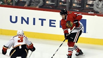 Nov 1, 2016; Chicago, IL, USA; Chicago Blackhawks center Nick Schmaltz (8) is defended by Calgary Flames defenseman Jyrki Jokipakka (3) during the first period at the United Center. Mandatory Credit: David Banks-USA TODAY Sports