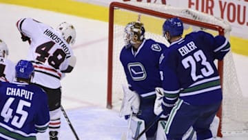 Nov 19, 2016; Vancouver, British Columbia, CAN; Chicago Blackhawks forward Vinnie Hinostroza (48) scores against Vancouver Canucks goaltender Jacob Markstrom (25) during the third period at Rogers Arena. The Chicago Blackhawks won 4-3 in overtime. Mandatory Credit: Anne-Marie Sorvin-USA TODAY Sports
