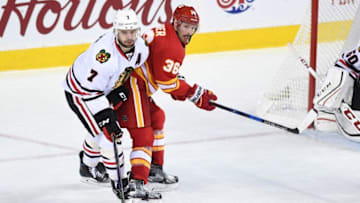 Nov 18, 2016; Calgary, Alberta, CAN; Calgary Flames right wing Troy Brouwer (36) and Chicago Blackhawks defenseman Brent Seabrook (7) collide at Scotiabank Saddledome. Blackhawks won 3-2. Mandatory Credit: Candice Ward-USA TODAY Sports