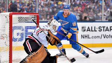 Jan 2, 2017; St. Louis, MO, USA; Chicago Blackhawks goalie Corey Crawford (50) makes a save as St. Louis Blues center Paul Stastny (26) looks on during the second period in the 2016 Winter Classic ice hockey game at Busch Stadium. Mandatory Credit: Jasen Vinlove-USA TODAY Sports