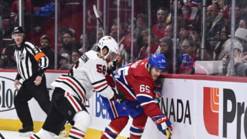MONTREAL, QC - MARCH 16: Erik Gustafsson #56 of the Chicago Blackhawks challenges Andrew Shaw #65 of the Montreal Canadiens near the boards in the third period during the NHL game at the Bell Centre on March 16, 2019 in Montreal, Quebec, Canada. (Photo by Minas Panagiotakis/Getty Images)