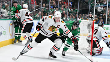 DALLAS, TX - NOVEMBER 21: Jonathan Toews #19 of the Chicago Blackhawks handles the puck against the Dallas Stars at the American Airlines Center on November 21, 2019 in Dallas, Texas. (Photo by Glenn James/NHLI via Getty Images)