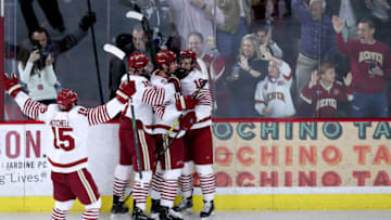 DENVER, COLORADO - MARCH 07: Forward Ryan Barrow #18 of the Denver Pioneers is embraced by teammates in front of cheering fans after scoring the team's third goal during the second period in a game between the Colorado College Tigers and the Denver Pioneers at Magness Arena on March 07, 2020 in Denver, Colorado. (Photo by Lizzy Barrett/Getty Images)