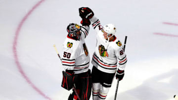 Corey Crawford #50, Adam Boqvist #27, Chicago Blackhawks (Photo by Jeff Vinnick/Getty Images)
