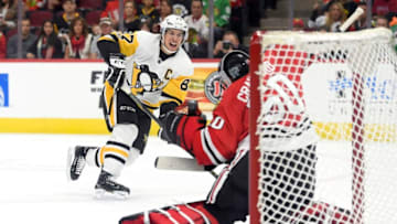 CHICAGO, IL - OCTOBER 05: Pittsburgh Penguins center Sidney Crosby (87) shoots the puck at Chicago Blackhawks goalie Corey Crawford (50) in the first period during a game between the Chicago Blackhawks and the Pittsburgh Penguins on October 5, 2017, at the United Center in Chicago, IL. (Photo by Robin Alam/Icon Sportswire via Getty Images)