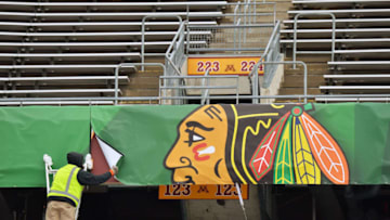 MINNEAPOLIS, MN - FEBRUARY 19: A worker installs a banner with the logo from the Chicago Blackhawks as part of the preparations for the 2016 Coors Light Stadium Series game between the Minnesota Wild and Chicago Blackhawks on February 19, 2016 at TCF Bank Stadium in Minneapolis, Minnesota. (Photo by Jamie Sabau/NHLI via Getty Images)