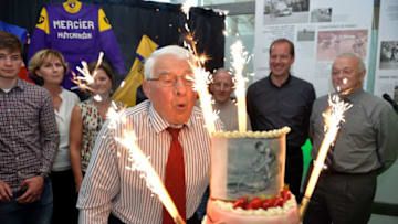 Former French cyclist, Raymond Poulidor (C) blows the candles on his birthday cake, flanked by relatives and friends including Tour de France cycling race director Christian Prudhomme (2nd R) and former Tour de France director Jean-Marie Leblanc (R), during the celebration of his 80th birthday, in Limoges on April 15, 2016. / AFP / PASCAL LACHENAUD (Photo credit should read PASCAL LACHENAUD/AFP/Getty Images)