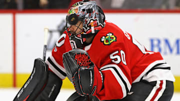 CHICAGO, IL - NOVEMBER 01: A puck flies past the head of Corey Crawford