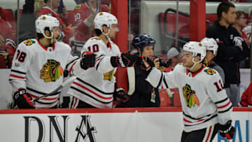 RALEIGH, NC - NOVEMBER 11: Chicago Blackhawks Right Wing Alex DeBrincat (12) is congratulated by his bench after scoring a goal in the third period during a game between the Carolina Hurricanes and the Chicago Blackhawks at the PNC Arena on Raleigh, NC on November 11, 2017. Chicago defeated Carolina 4-3 in overtime. (Photo by Greg Thompson/Icon Sportswire via Getty Images)
