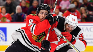 CHICAGO, IL - NOVEMBER 12: Chicago Blackhawks center Nick Schmaltz (8) and New Jersey Devils left wing Brian Gibbons (39) battle for position during the game between the New Jersey Devils and the Chicago Blackhawks on November 12, 2017 at the United Center in Chicago, Illinois. (Photo by Quinn Harris/Icon Sportswire via Getty Images)