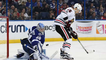 TAMPA, FL - NOVEMBER 22: Tampa Bay Lightning goalie Andrei Vasilevskiy (88) makes a save on the redirected shot from Chicago Blackhawks center Artem Anisimov (15) in the 3nd period of the NHL game between the Chicago Blackhawks and Tampa Bay Lightning on November 22, 2017 at Amalie Arena in Tampa, FL. (Photo by Mark LoMoglio/Icon Sportswire via Getty Images)