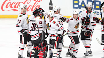 SUNRISE, FL - NOVEMBER 25: Teammates congratulate goaltender Corey Crawford
