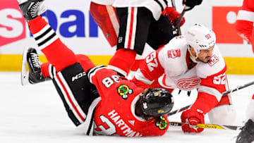 CHICAGO, IL - JANUARY 14: Detroit Red Wings defenseman Jonathan Ericsson (52) knocks Chicago Blackhawks left wing Ryan Hartman (38) to the ice during the game between the Chicago Blackhawks and the Detroit Red Wings on January 14, 2018 at the United Center in Chicago, Illinois. (Photo by Quinn Harris/Icon Sportswire via Getty Images)