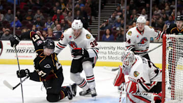CLEVELAND, OH - JANUARY 19: Cleveland Monsters left wing Paul Bittner (57) attempts to backhand the puck past Rockford IceHogs goalie Matt Tomkins (31) as Rockford IceHogs defenceman Carl Dahlstrom (32) defends during the second period of the American Hockey League game between the Rockford IceHogs and Cleveland Monsters on January 19, 2018, at Quicken Loans Arena in Cleveland, OH. Rockford defeated Cleveland 4-3. (Photo by Frank Jansky/Icon Sportswire via Getty Images)