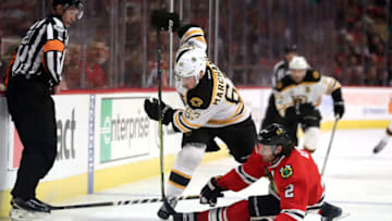 CHICAGO, IL - APRIL 02: Chicago Blackhawks defenseman Duncan Keith (2) battles with Boston Bruins left wing Brad Marchand (63) for a loose puck during the first period of a game between the Chicago Blackhawks and the Boston Bruins on April 02, 2017, at the United Center in Chicago, IL.(Photo by Robin Alam/Icon Sportswire via Getty Images)